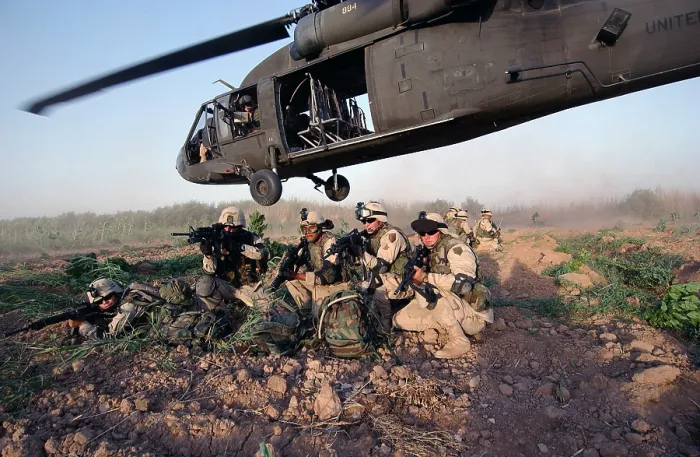 Framed Print : A Quick Response Force brace themselves in a security posture after being dropped off by a Black Hawk helicopter on a mission in Iraq. June 19 2004. (BSLOC_2011_12_152)