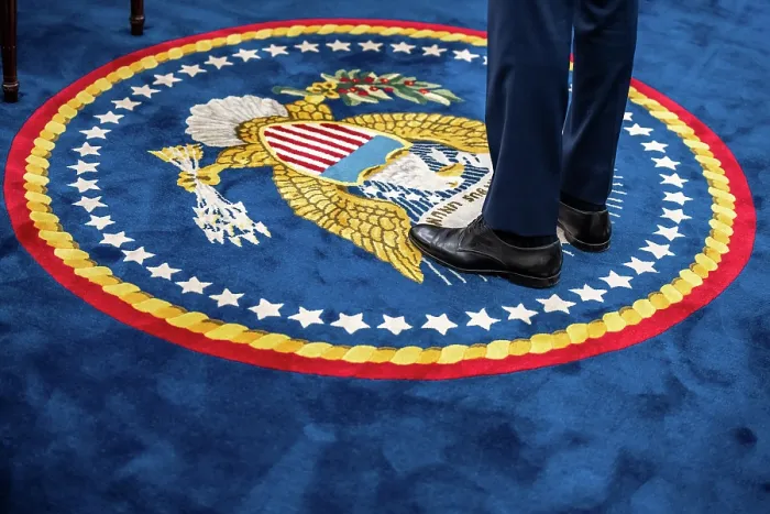 Framed Print : A quixotic portrait of President Joe Biden, including only his lower legs and shoes on the presidential seal of the Oval Office carpet, August 29, 2023. (BSLOC_2023_8_5)