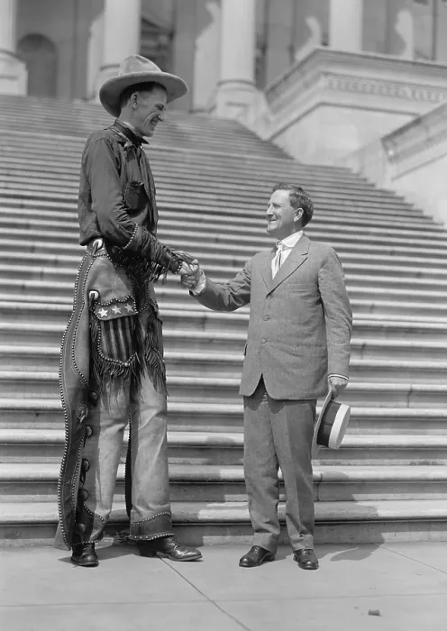 Framed Print : Ralph E. Madsen, the Tall Cowboy, shaking hands with Sen. Morris Sheppard, 1919. The Nebraska born Madsen was 7 feet 6 inches tall