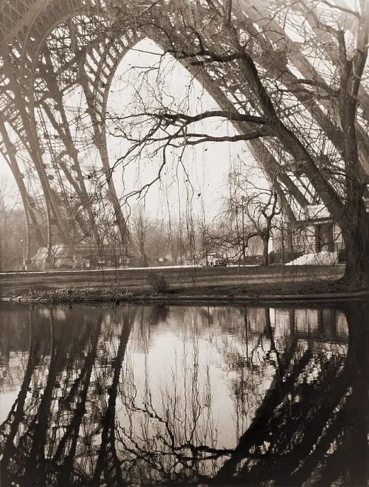 Framed Print : A rare unpopulated winter view of the girders of the Eiffel Tower reflected in the placid waters beneath the tower in Paris. February 1961