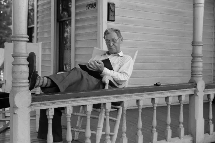 Framed Print : Reading a good book. Middle age man reading on his front porch on a Sunday afternoon in July 1941. Vincennes, Indiana