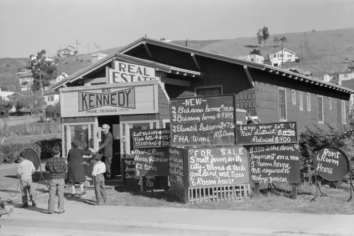 Framed Print : Real estate office in Oakland, California, advertises homes selling for less than $5, 000. Dec. 1940
