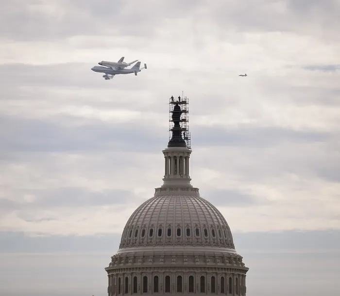 Framed Print : Retiring space shuttle Discovery atop a NASA 747, flies by the U.S. Capitol. Discovery's new home will be the National Air and Space Museum. April 17, 2012