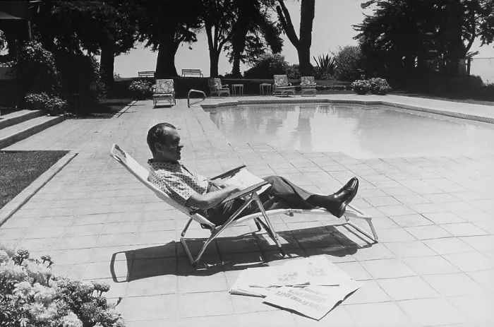 Framed Print : Richard Nixon reading newspapers while sitting by the pool in San Clemente. Ca. 1969-74