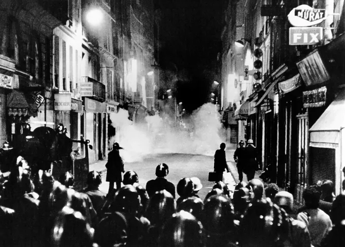 Framed Print : Riot policemen at a burning barricade on the Rue de Seine, a narrow Latin Quarter side street