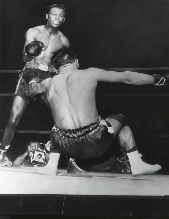 Framed Print : Robert Villemain, goes down from a punch by Sugar Ray Robinson in the 12th round. French middleweight got up and completed the fight. Robinson won by unanimous decision