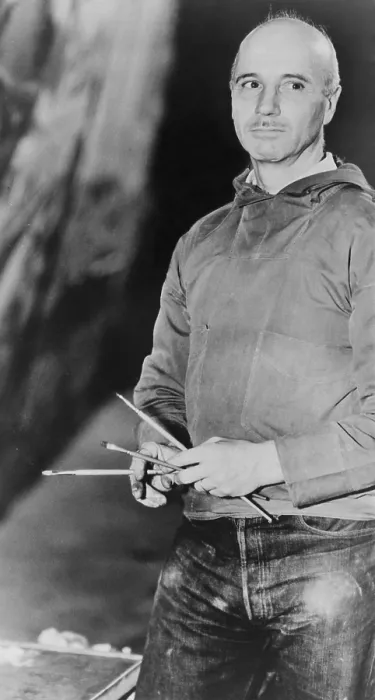 Framed Print : Rockwell Kent (1882-1971), American realist painter holding paint brushes, 1939