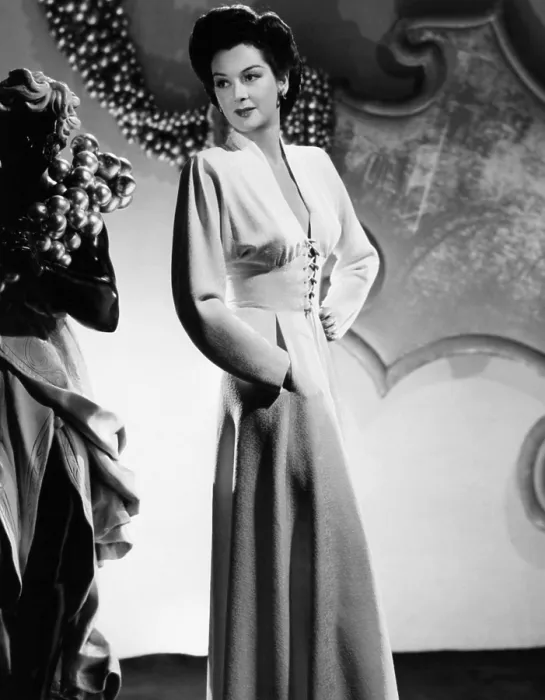Framed Print : Rosalind Russell in a v-neckline dinner dress designed by Adrian, 1941