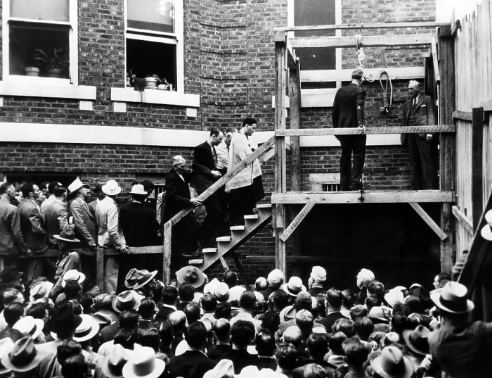 Framed Print : Roscoe Red Jackson (behind priest) walks up the steps before he is hanged. He was convicted of killing a travelling salesman who gave him a ride. Galena, Missouri, 1937