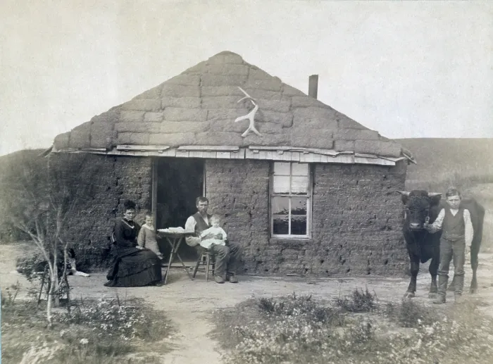 Framed Print : Rural life in Nebraska. The Laulerman family in front of their sod house, with boy holding bull on the right. 1886