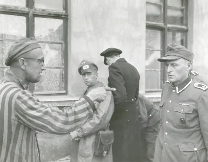 Framed Print : Russian slave laborer points out Nazi guard who brutally beat prisoners. The U.S. Army 3rd Armored Division liberated Buchenwald concentration Camp