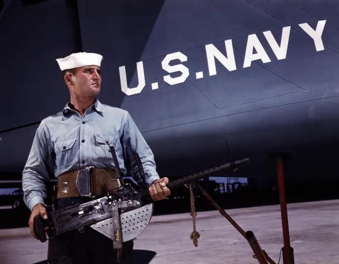 Framed Print : A sailor holds a.30 caliber machine gun at the Naval Air Base, Corpus Christi, TX, 1942