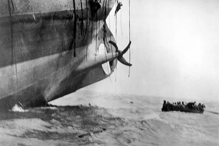 Framed Print : Sailors escape from vessel torpedoed by German submarine in World War I. The ship's bow has already sunk into the waves, and the stern is lifting out of the water Framed Print : Sailors escape from vessel torpedoed by German submarine in World War I. The ship's bow has already sunk into the waves, and the stern is lifting out of the water