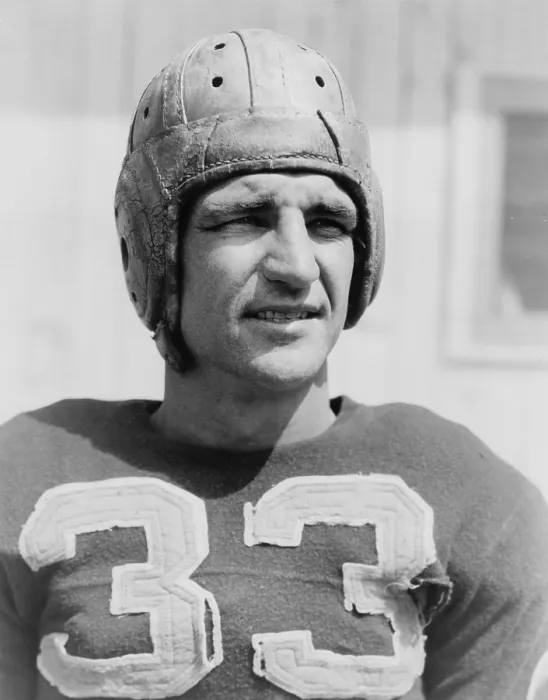 Framed Print : Sammy Baugh (1914-2008), wearing a tattered football jersey and helmet, 1938. He played in the National Football League for the Washington Redskins from 1937 to 1952