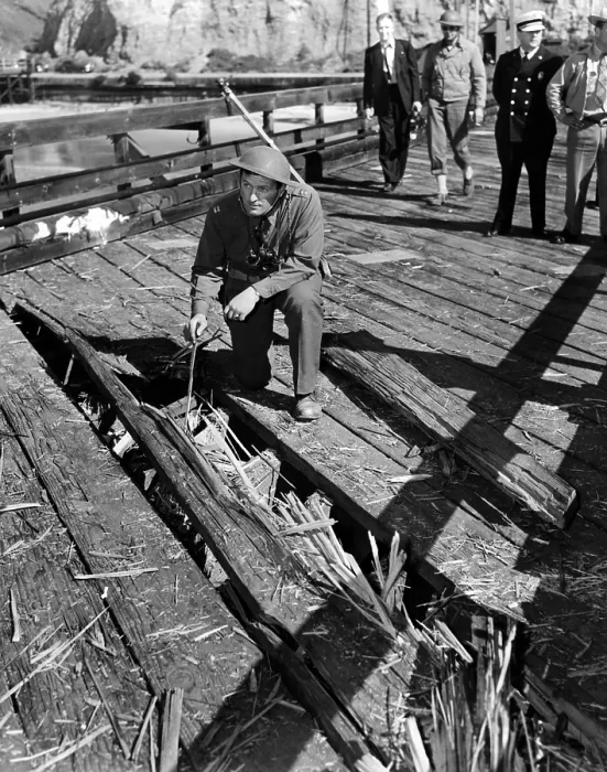 Framed Print : The Santa Barbara oil field was shelled by a Japanese submarine. A soldier examines a path grooved in an ocean pier aimed at the oil field