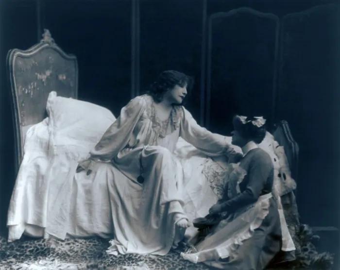 Framed Print : Sarah Bernhardt (1844-1923), French actress, in the role of the dying Camille, with her maid helping her put on her slippers. Ca. 1887 Framed Print : Sarah Bernhardt (1844-1923), French actress, in the role of the dying Camille, with her maid helping her put on her slippers. Ca. 1887