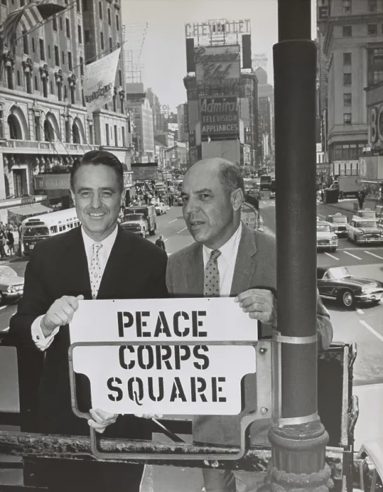 Framed Print : Sargent Shriver and Edward R. Dudley in Times Square with a sign Peace Corps Square