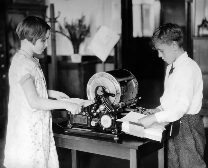 Framed Print : School children work on a mimeograph machine Framed Print : School children work on a mimeograph machine