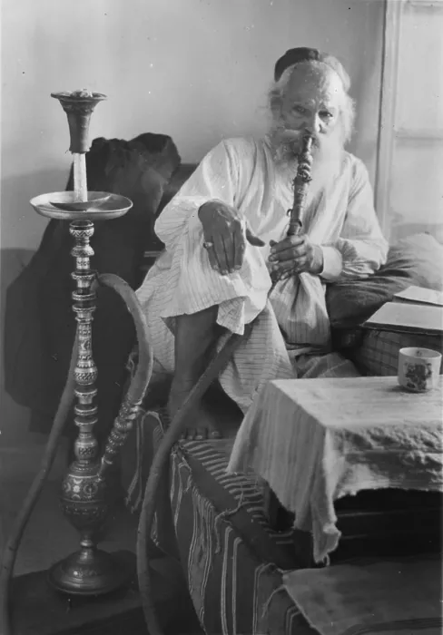 Framed Print : Seated man smoking a nargile, or water pipe, photograph, 1898-1946