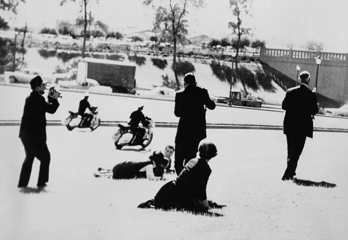 Framed Print : Seconds after John F. Kennedy's assassination two policemen on motorcycles speed by as some spectators cower on the ground, while three continue to take pictures. Nov Framed Print : Seconds after John F. Kennedy's assassination two policemen on motorcycles speed by as some spectators cower on the ground, while three continue to take pictures. Nov