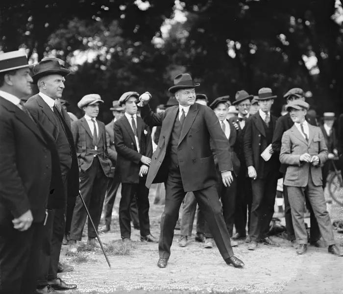 Framed Print : Secretary of Commerce, Herbert Hoover (1874-1964), throws a baseball while a small crowd watches, 1922