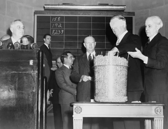Framed Print : Secretary of Navy Frank Knox, blindfolded, drawing a number from the first peacetime military draft lottery in October 1940