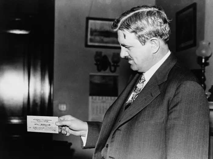 Framed Print : Senator Clarence C. Dill of Washington state, holding one of the wooden dollars used by town of Tenino, Washington Framed Print : Senator Clarence C. Dill of Washington state, holding one of the wooden dollars used by town of Tenino, Washington