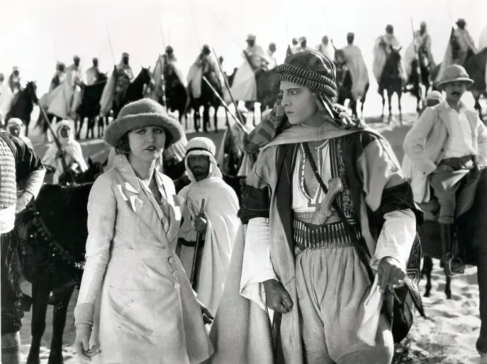 Framed Print : THE SHEIK, from left, Agnes Ayres, Rudolph Valentino, (background, right, Adolphe Menjou), 1921