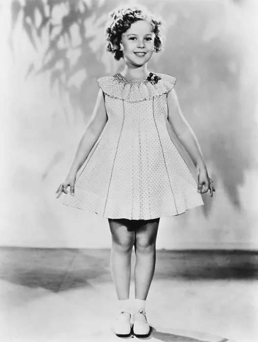 Framed Print : Shirley Temple, modeling a dotted-Swiss dress, ca. 1936