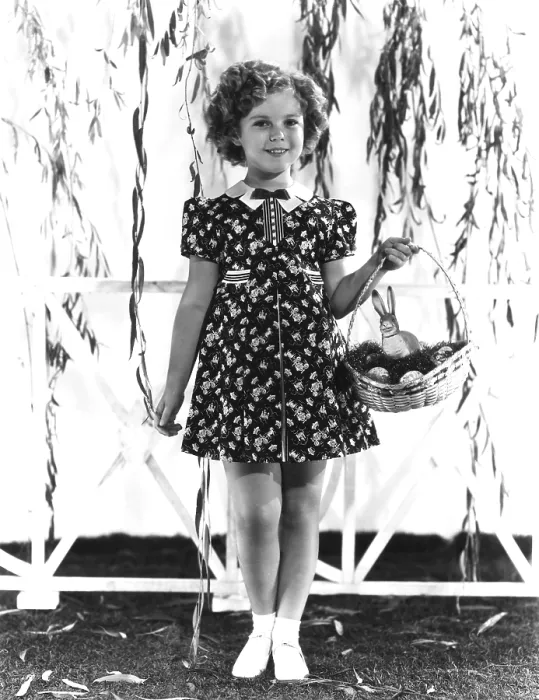 Framed Print : Shirley Temple, modeling a red, white and blue print dress with a blue velvet bow at the neck, ca. 1936 Framed Print : Shirley Temple, modeling a red, white and blue print dress with a blue velvet bow at the neck, ca. 1936