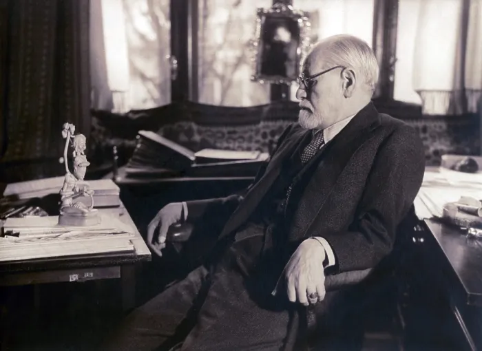 Framed Print : Sigmund Freud seated in his study contemplating a carved figurine (possibly Javanese) on his desk in 1937 photography by Princess Marie Bonaparte Framed Print : Sigmund Freud seated in his study contemplating a carved figurine (possibly Javanese) on his desk in 1937 photography by Princess Marie Bonaparte