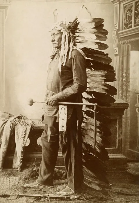 Framed Print : Sitting Bull, 1888, studio photo by David Francis Barry. The 56-58 year-old warrior wears a long, feathered headdress and holds a war club (BSLOC_2019_9_128)