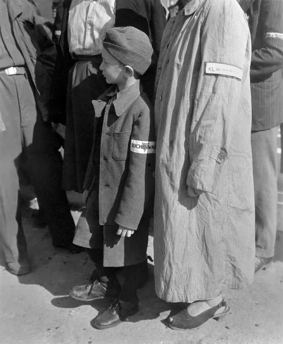 Framed Print : Six-year-old war orphan with a Buchenwald concentration camp badge on his sleeve. He waits for his name to be called for his departure to Switzerland Framed Print : Six-year-old war orphan with a Buchenwald concentration camp badge on his sleeve. He waits for his name to be called for his departure to Switzerland