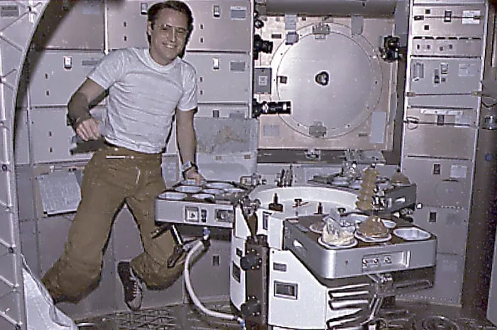 Framed Print : Skylab 4 Astronaut Ed Gibson preparing his meal aboard the Skylab space station. Skylab 4 mission lasted 84 days, testing the effects of prolonged zero gravity. Nov