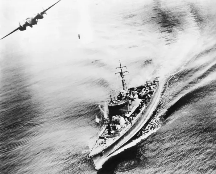 Framed Print : Small Japanese war vessel bombed by U.S. B-25 bomber in the Bismarck Sea, March 21, 1944. The ships crew can be seen running for cover