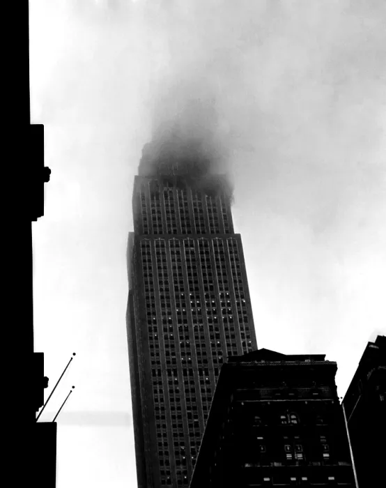 Framed Print : Smoke pours from the windows of the Empire State Building after a B-25 Bomber accidentally crashed into the 78th story. New York, New York. July 28, 1945