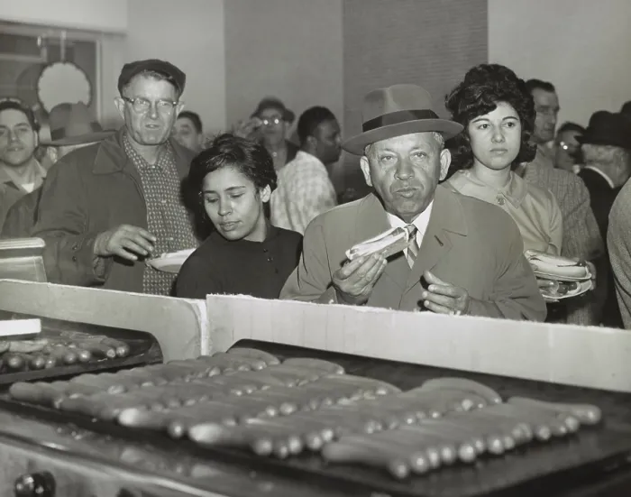 Framed Print : Sol Handwerker eating a Famous Coney Island hot dog at SNACKTIME, his new eatery on 34th Street in Manhattan, Sept. 17, 1963