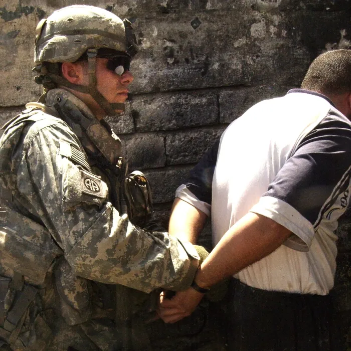 Framed Print : US soldier cuffs an Iraqi man suspected of making improvised explosive devices during the Iraq insurgency. Mosul Iraq. June 5 2007. (BSLOC_2011_12_147) Framed Print : US soldier cuffs an Iraqi man suspected of making improvised explosive devices during the Iraq insurgency. Mosul Iraq. June 5 2007. (BSLOC_2011_12_147)