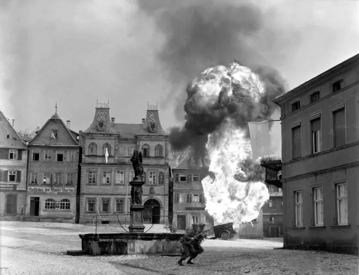 Framed Print : Two soldiers dash past a blazing German gasoline trailer in town square of Kronach, Germany. U.S. 101st Infantry, April 14, 1945. World War 2. (BSLOC_2014_8_75) Framed Print : Two soldiers dash past a blazing German gasoline trailer in town square of Kronach, Germany. U.S. 101st Infantry, April 14, 1945. World War 2. (BSLOC_2014_8_75)