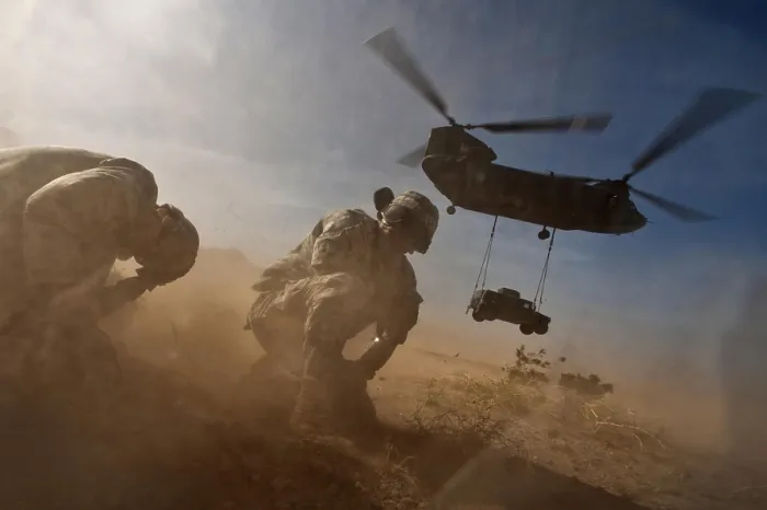 Framed Print : Soldiers in the dust of a Chinook helicopter hauling a Humvee at Nellis Air Force Base Nevada. April 15 2011. (BSLOC_2011_12_271)