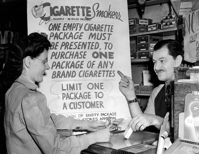 Framed Print : Solution for the wartime cigarette shortage. Ted Pollack, a drug store manager, wants to keep his cigarettes off the black market