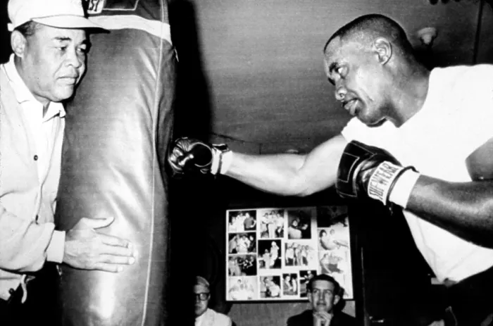 Framed Print : Sonny Liston working out on the heavy bag while Joe Louis holds it, 4 / 13 / 65 CSU Archives / Everett Collection