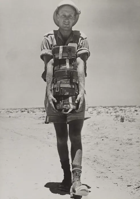 Framed Print : A South African with the British forces in the Western Desert holding a stack of land mines