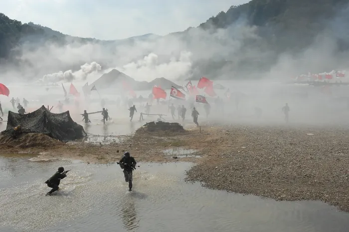 Framed Print : South Korean soldiers dressed as North Korean infantry charge South Korean defenses at the re-enactment of the Nakdong River Battle during the 60th anniversary commemoration of