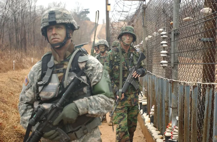 Framed Print : South Korean and US Soldiers patrol long a fence at the United Nations Security Area in Panmunjom during an annual training exercise. March 24 2007. (BSLOC_2011_12_198)