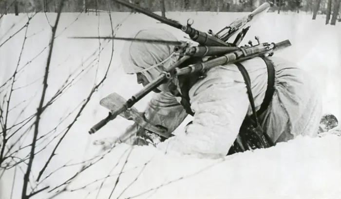 Framed Print : Soviet (Russian) World War 2 medic collects rifles from as he treats soldiers in battle. May 1942. (BSLOC_2014_8_28)