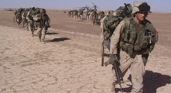 Framed Print : An Special Operations infantry company move across the desert in a file after the seizure of a forward operating baseduring the U.S