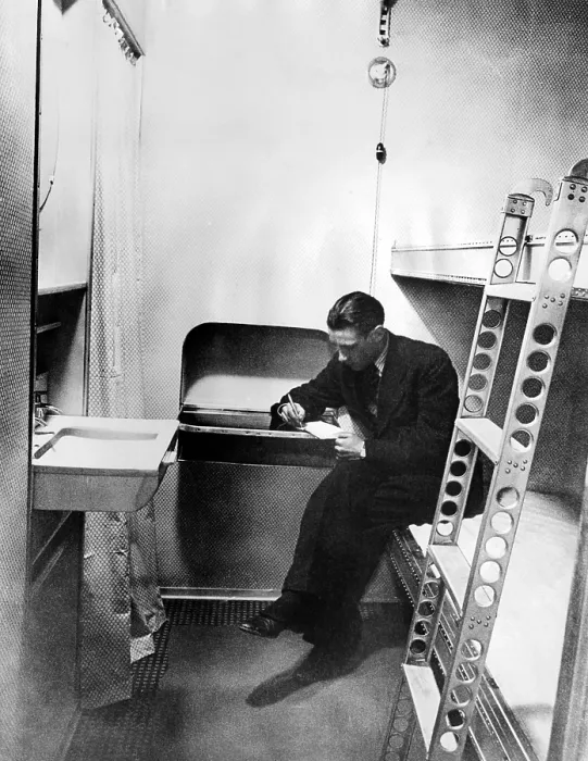 Framed Print : Stateroom on the dirigible, Hindenburg. The cabin is equipped with hot and cold running water, upper and lower bunks, and a built in writing table. March 17, 1936 Framed Print : Stateroom on the dirigible, Hindenburg. The cabin is equipped with hot and cold running water, upper and lower bunks, and a built in writing table. March 17, 1936