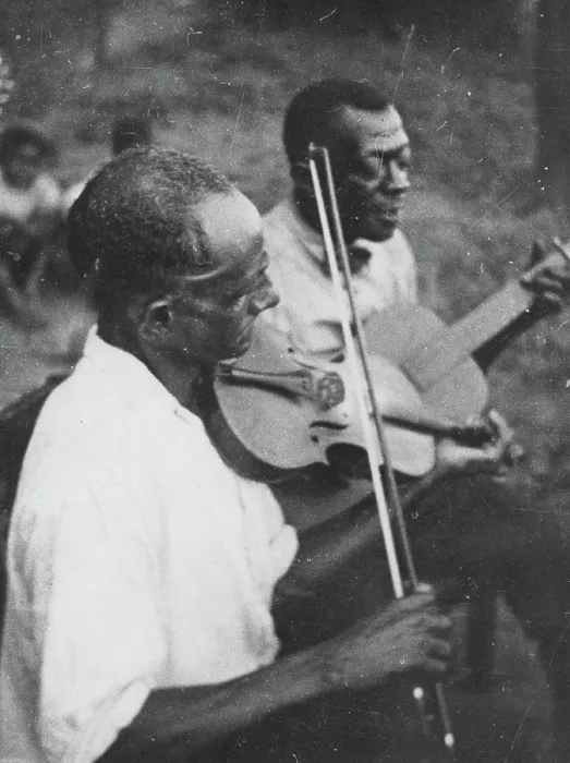 Framed Print : Stavin Chain playing guitar and singing accompanied by a musician on violin, Lafayette, La. June 1934