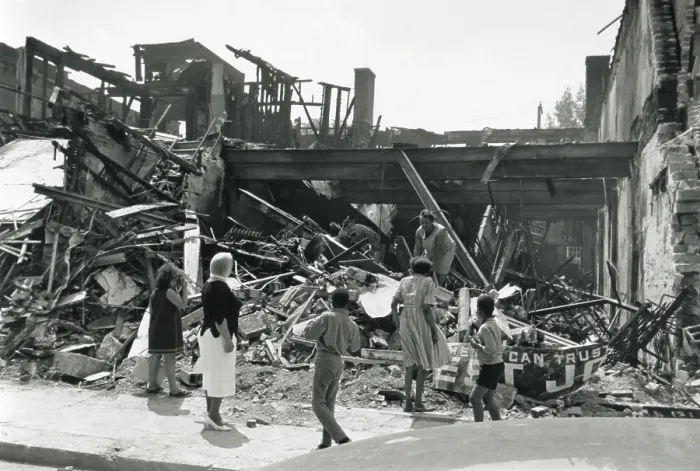 Framed Print : Store destroyed during the Detroit, Michigan, Riots of July 1967. An African American woman searches the ruins as pedestrians look on. (BSLOC_2015_14_105)